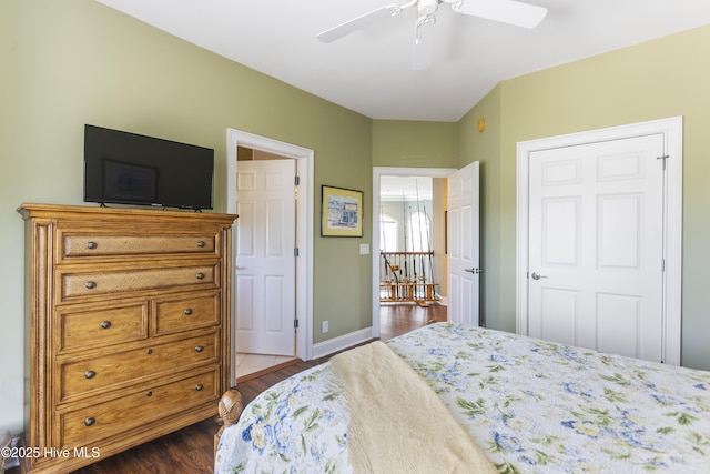 bedroom featuring ceiling fan, baseboards, and dark wood-style flooring