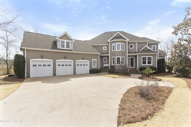 view of front of home featuring concrete driveway, a garage, and roof with shingles