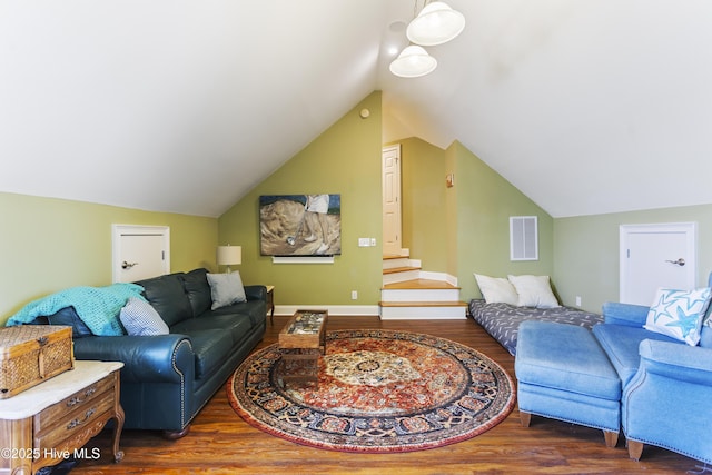 living room with visible vents, baseboards, stairs, lofted ceiling, and wood finished floors