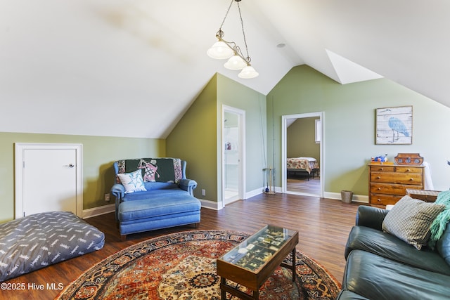 living area with baseboards, lofted ceiling, and wood finished floors