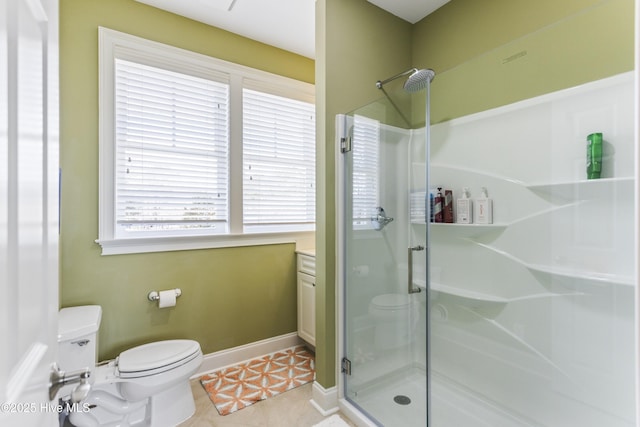 bathroom with tile patterned flooring, a shower stall, toilet, and baseboards