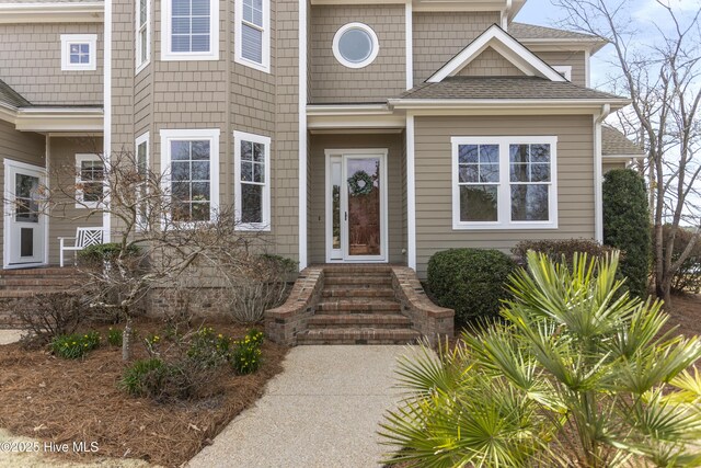 property entrance with roof with shingles