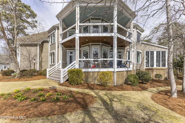 view of front of home featuring a balcony and a sunroom