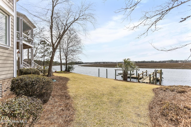 view of yard featuring a dock and a water view