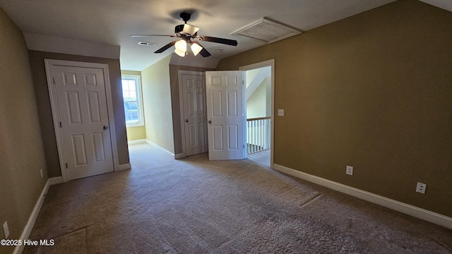 unfurnished bedroom featuring baseboards, carpet floors, visible vents, and attic access