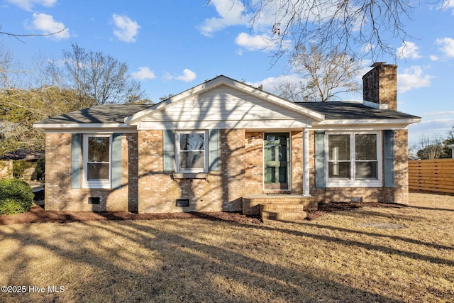 view of front of home featuring crawl space, a chimney, fence, and brick siding