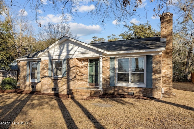 single story home with a shingled roof, crawl space, brick siding, and a front lawn