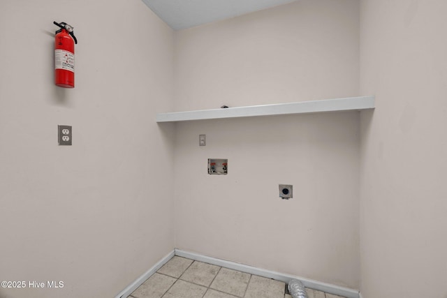 clothes washing area with laundry area, hookup for a washing machine, baseboards, and electric dryer hookup