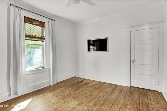 unfurnished room featuring visible vents, wood-type flooring, crown molding, baseboards, and ceiling fan