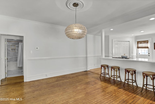 dining area with recessed lighting, crown molding, baseboards, and hardwood / wood-style floors
