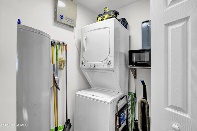 clothes washing area with stacked washing maching and dryer