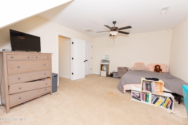 bedroom featuring a ceiling fan, light carpet, and visible vents