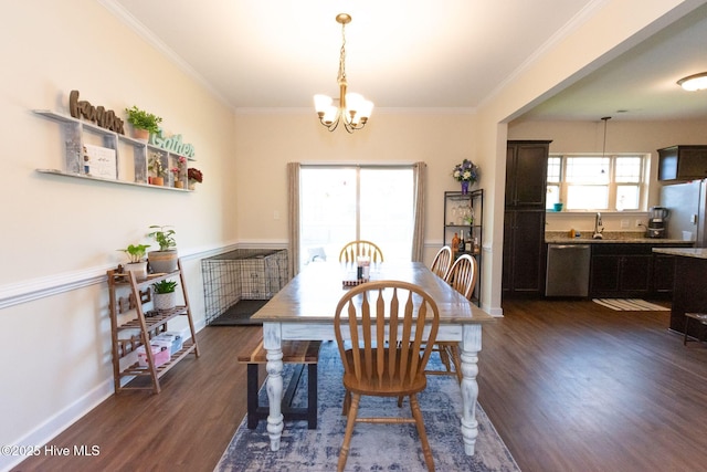 dining room featuring an inviting chandelier, baseboards, ornamental molding, and dark wood finished floors