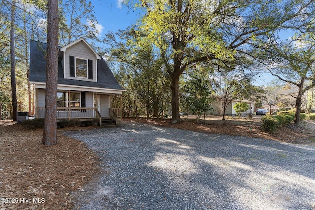 view of front of house featuring a shingled roof and a porch