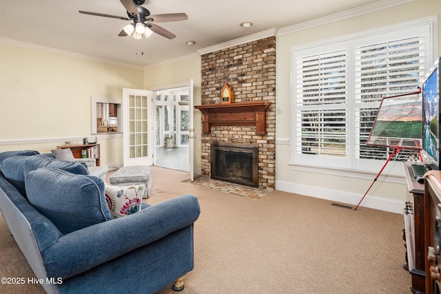 living room featuring ceiling fan, visible vents, ornamental molding, a brick fireplace, and carpet