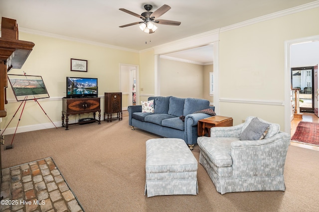 carpeted living room with ceiling fan, baseboards, and crown molding