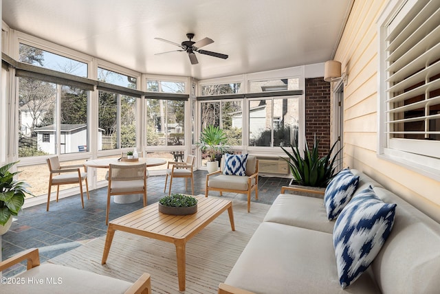 sunroom / solarium featuring a healthy amount of sunlight and ceiling fan