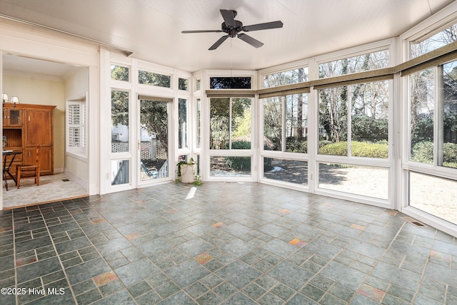 unfurnished sunroom featuring a ceiling fan