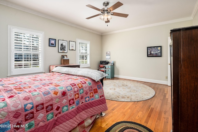 bedroom featuring ornamental molding, baseboards, ceiling fan, and hardwood / wood-style floors