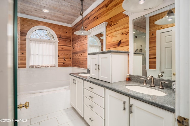 bathroom featuring a garden tub, wooden walls, a sink, tile patterned floors, and double vanity