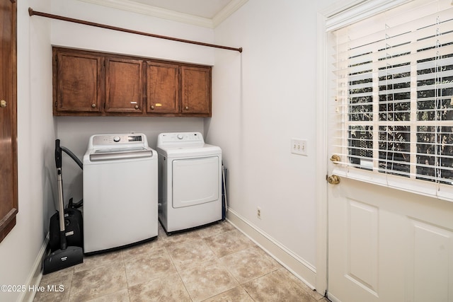 laundry area with light tile patterned floors, baseboards, ornamental molding, independent washer and dryer, and cabinet space