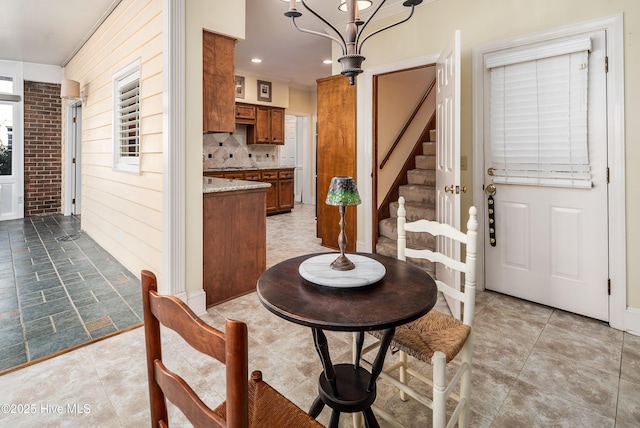 dining area featuring stairway, recessed lighting, and an inviting chandelier