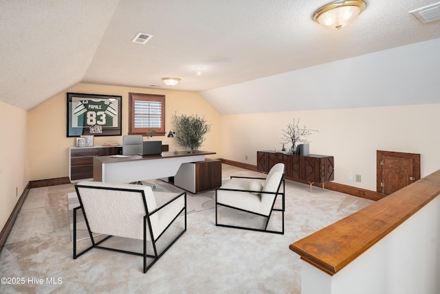 office space with baseboards, visible vents, vaulted ceiling, and a textured ceiling