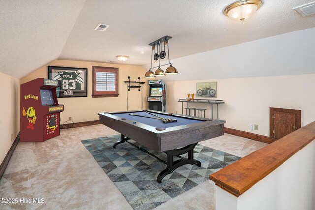 recreation room with visible vents, vaulted ceiling, a textured ceiling, and baseboards