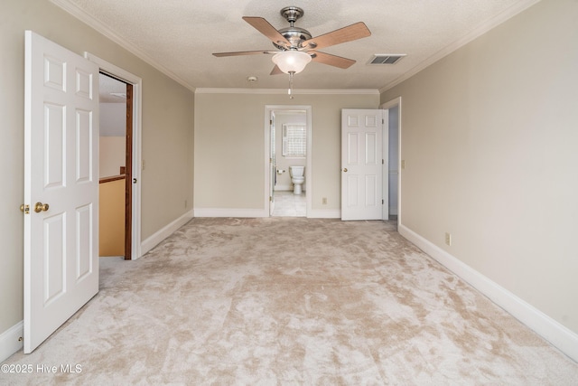 unfurnished room with visible vents, crown molding, a textured ceiling, and carpet flooring