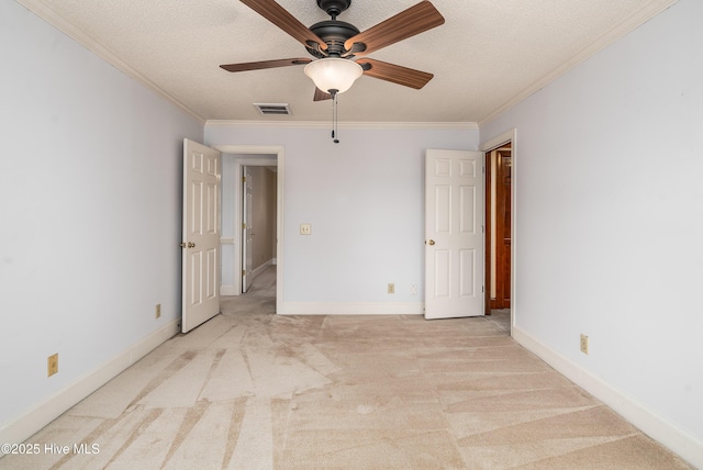 unfurnished bedroom featuring ornamental molding, carpet, visible vents, and baseboards