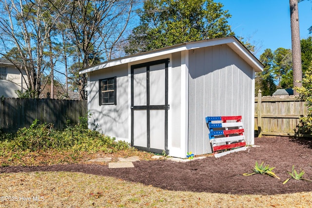 view of shed with fence