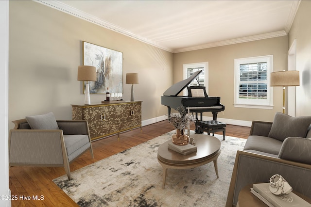 living area featuring baseboards, wood finished floors, and crown molding