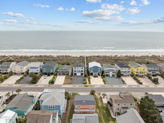 bird's eye view with a residential view, a water view, and a beach view