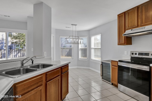 kitchen with beverage cooler, light countertops, stainless steel range with electric cooktop, under cabinet range hood, and a sink