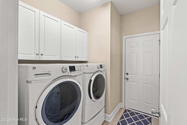 clothes washing area with light tile patterned floors, baseboards, cabinet space, and washing machine and dryer