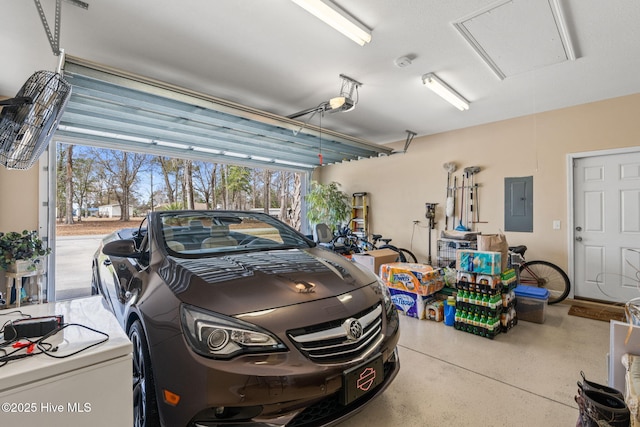 garage featuring electric panel and a garage door opener