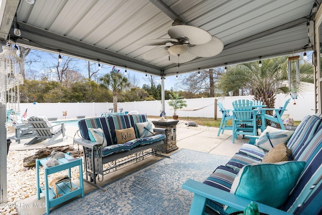 view of patio / terrace featuring a fenced in pool, an outdoor hangout area, a fenced backyard, and a ceiling fan