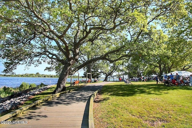 view of home's community featuring a yard and a water view