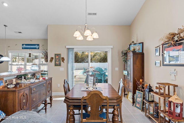 dining space featuring light tile patterned floors, a notable chandelier, baseboards, and visible vents