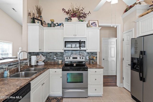 kitchen featuring light tile patterned floors, visible vents, a sink, white cabinets, and appliances with stainless steel finishes