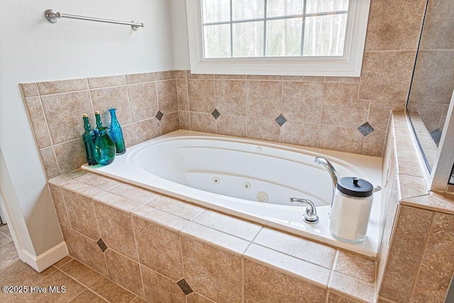 full bath with a tub with jets and tile patterned floors