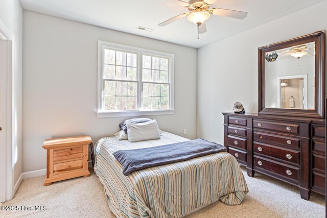 bedroom featuring visible vents, a ceiling fan, and light colored carpet