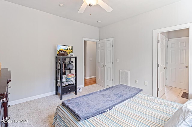 bedroom with a ceiling fan, visible vents, and baseboards
