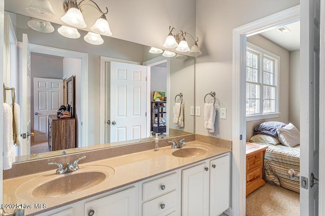 ensuite bathroom with ensuite bathroom, double vanity, a sink, and visible vents