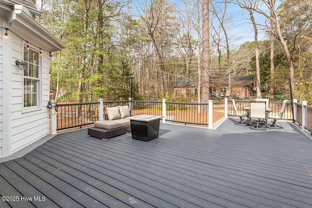 deck featuring outdoor dining space and outdoor lounge area