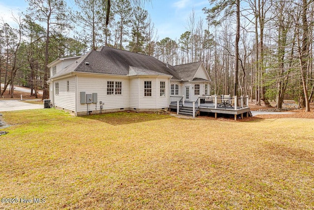 back of house with crawl space, a yard, and a wooden deck