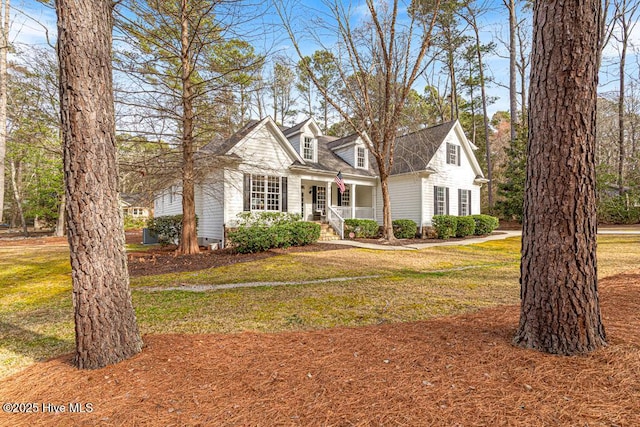 cape cod house with a front lawn