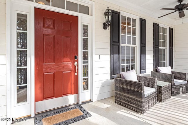 property entrance with a ceiling fan and covered porch
