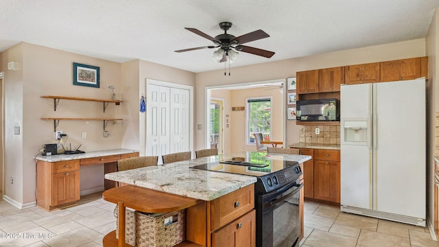 kitchen with brown cabinetry, open shelves, a kitchen island, a ceiling fan, and black appliances