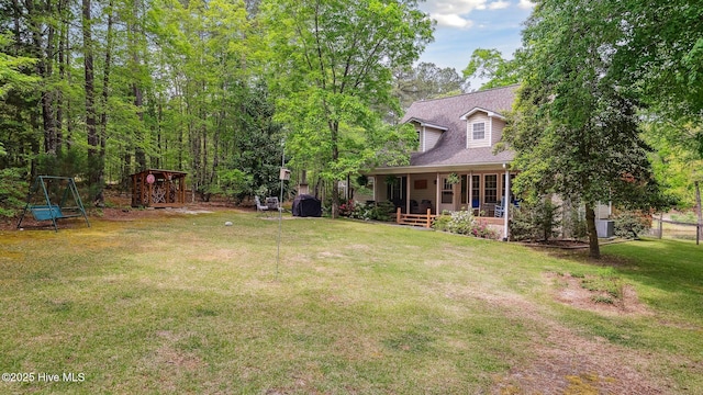view of yard featuring fence and a porch